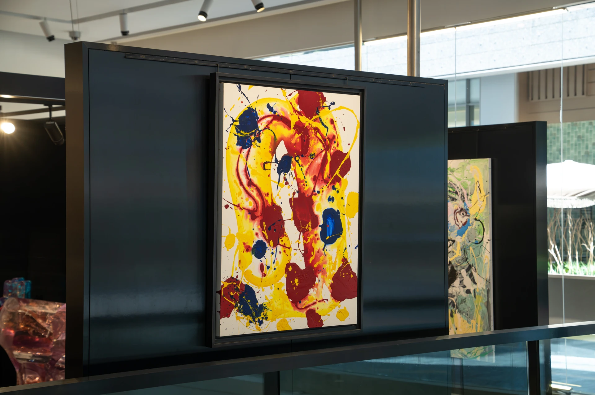 Abstract painting on a black display wall at Opera Gallery DIFC