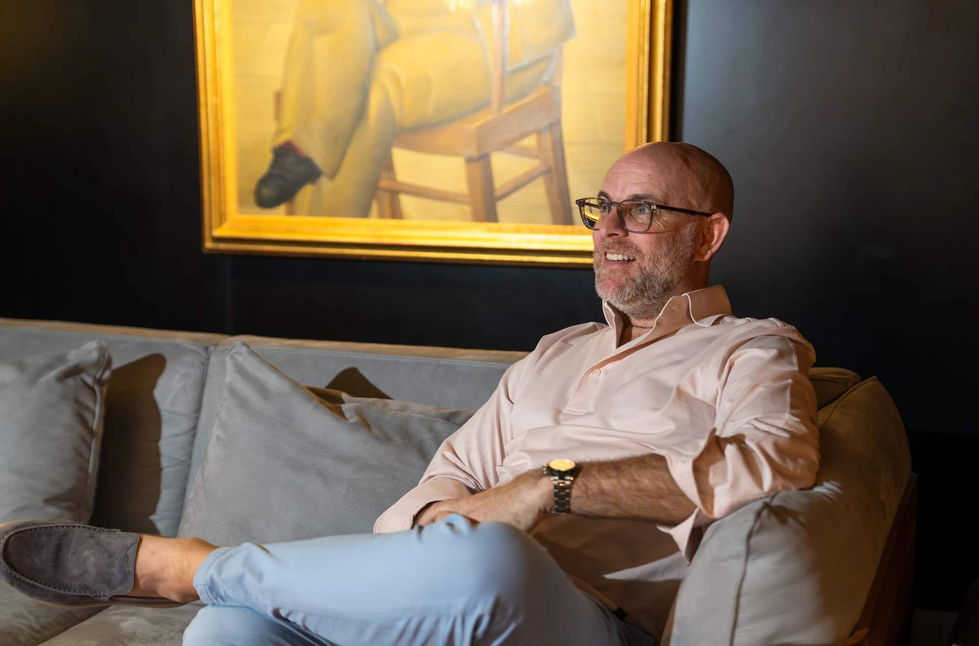Opera Gallery DIFC director seated beneath a painting