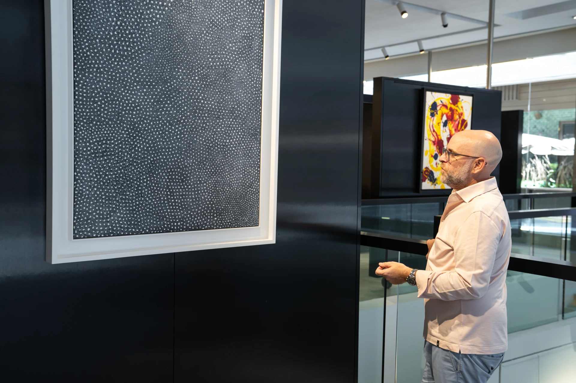 Viewing a large textured monochrome artwork at Opera Gallery DIFC